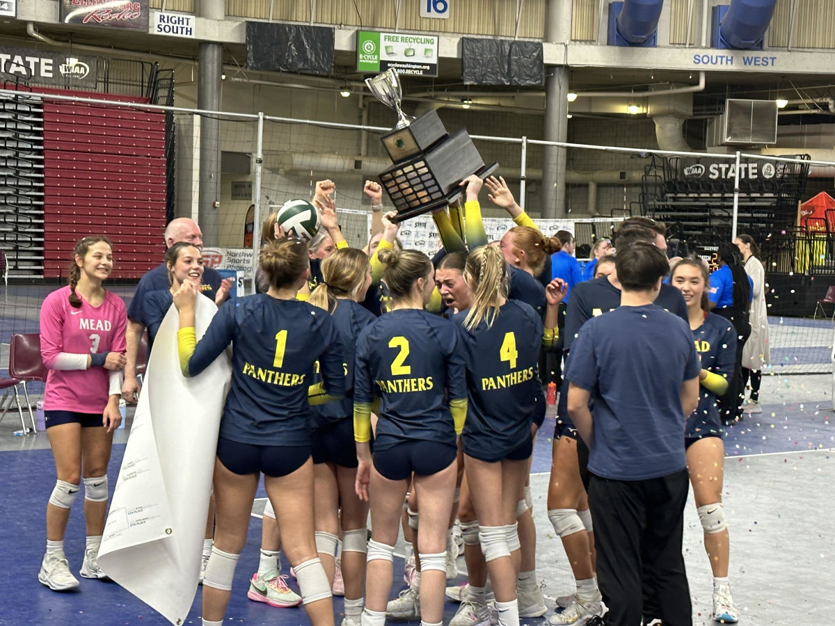 Mead players and coaches celebrate Saturday night's victory against Lake Washington in the Class 3A championship match in the Yakima Valley SunDome.
